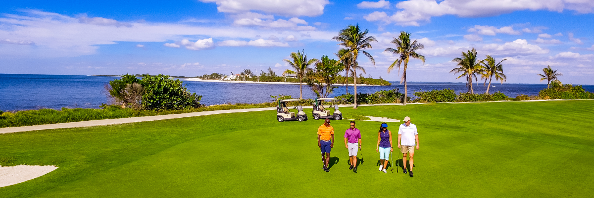 Group golfing on course overlooking the Gulf of Mexico 
